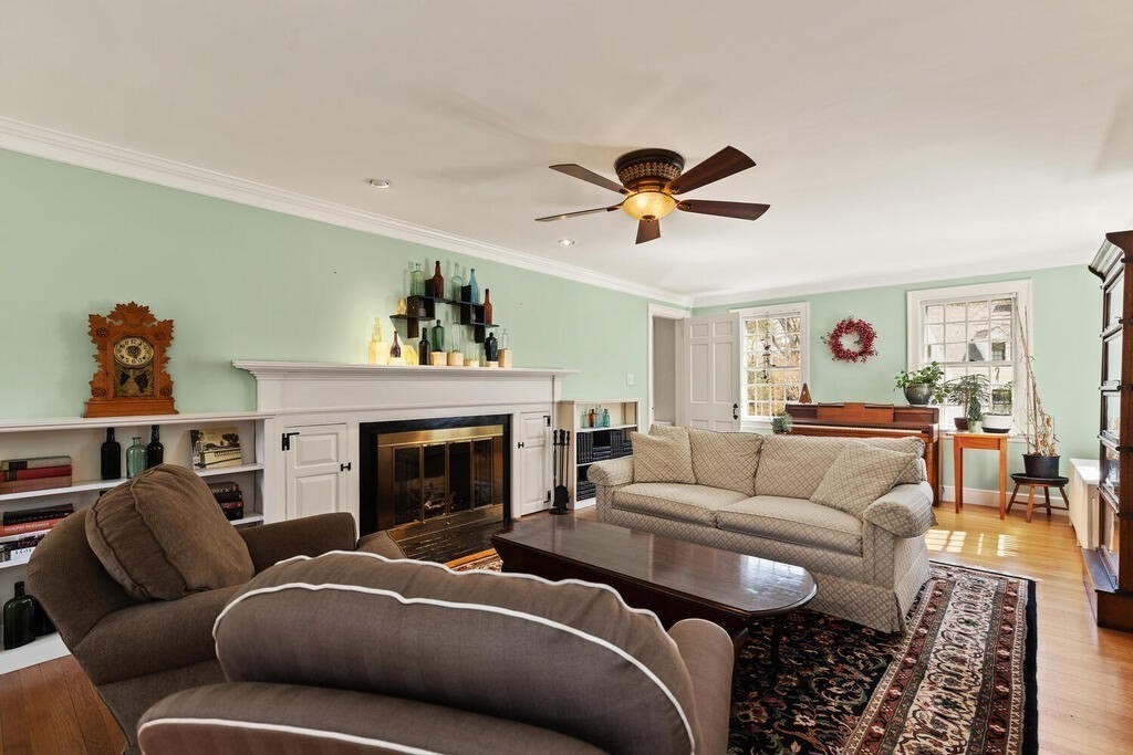 6 Lantern Lane Winchester, MA 01890 - Photo 10 of 40 a living room with furniture a fireplace and a chandelier