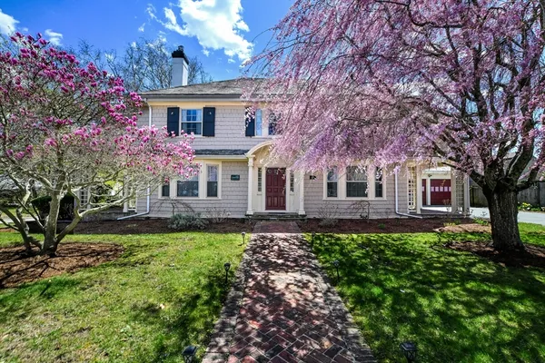 a front view of a house with a garden