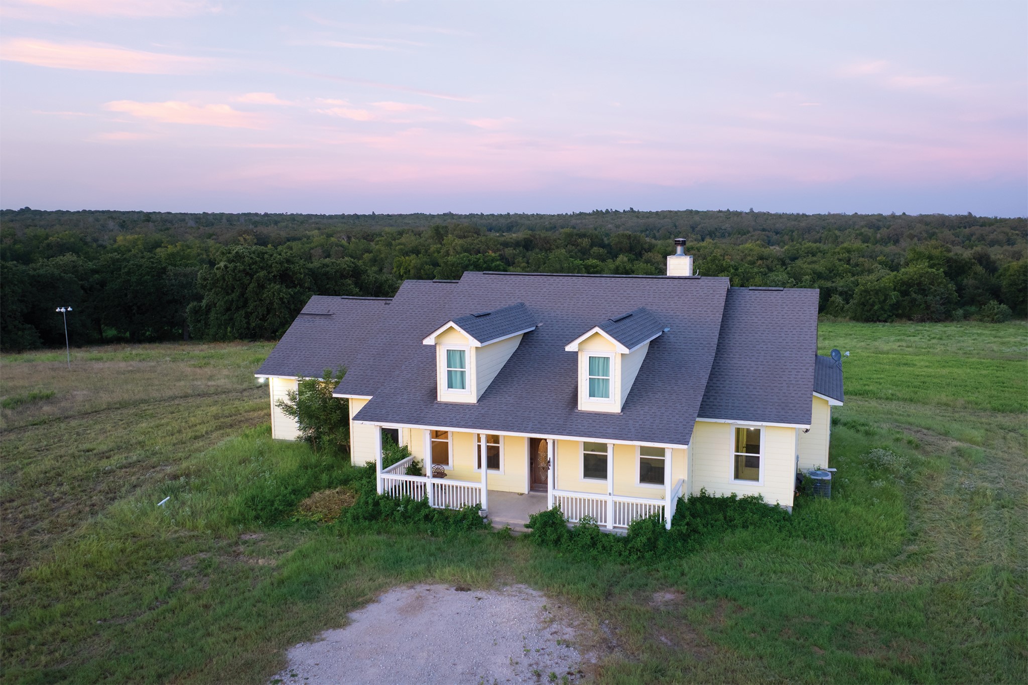 498 North County Line Road Elgin, TX 78621 - Photo 18 of 40 View of subject property featuring a forest