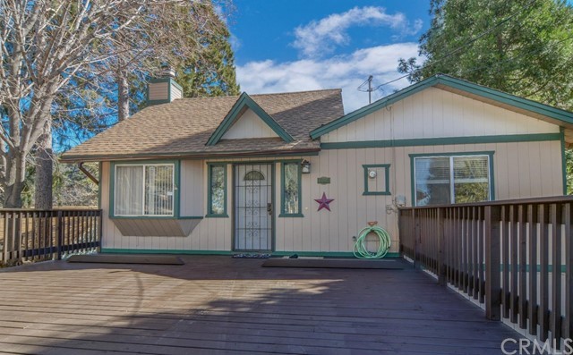 a front view of a house with a garden and plants