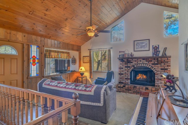 347 Donner Drive Crestline, CA 92325 - Photo 4 of 27 a living room with furniture a flat screen tv and a fireplace