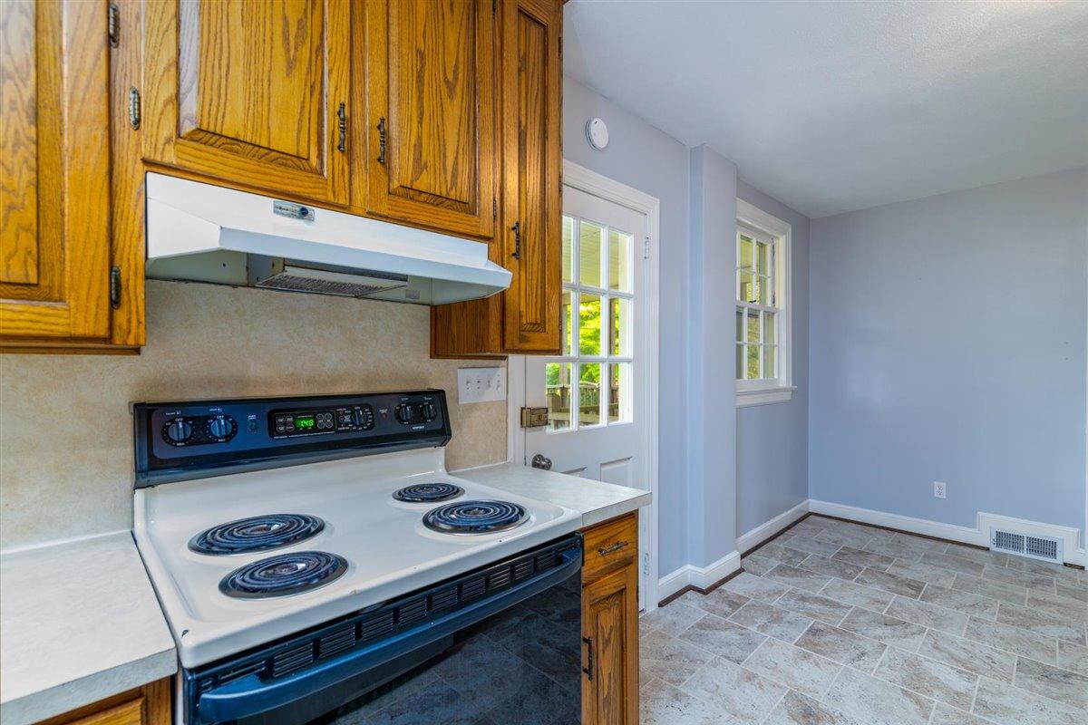 3223 Lawndale Road Roanoke, VA 24018 - Photo 12 of 37 a kitchen with a stove and a microwave