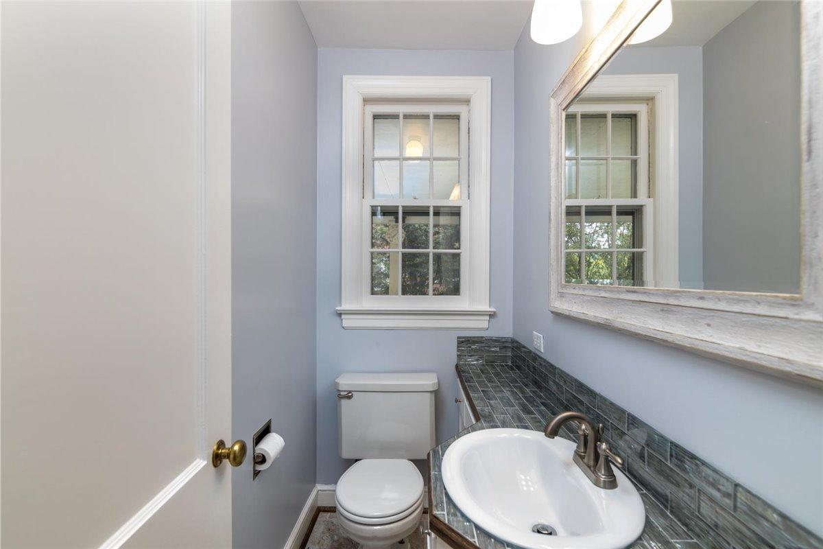 3223 Lawndale Road Roanoke, VA 24018 - Photo 16 of 37 a bathroom with a toilet a sink and mirror