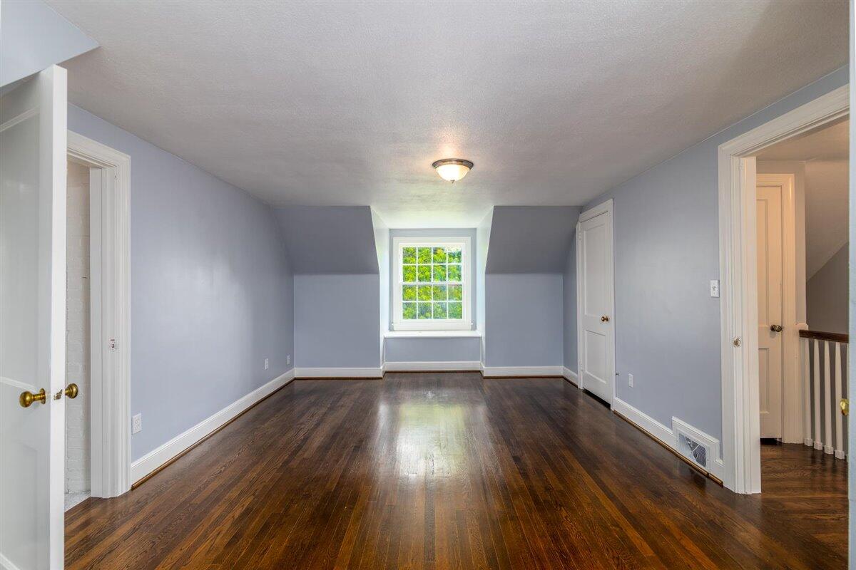 3223 Lawndale Road Roanoke, VA 24018 - Photo 19 of 37 a view of an empty room with wooden floor and a window