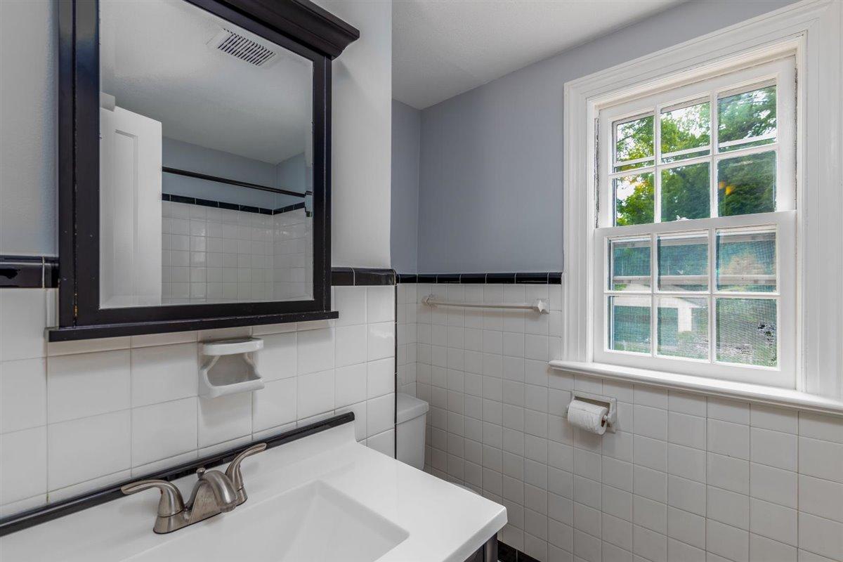 3223 Lawndale Road Roanoke, VA 24018 - Photo 22 of 37 a bathroom with a sink and a mirror