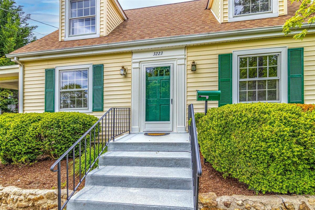 3223 Lawndale Road Roanoke, VA 24018 - Photo 4 of 37 a front view of a house with a large window and potted plants