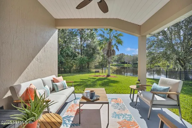 a view of yard from deck with patio