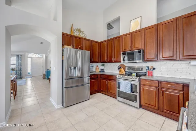 a kitchen with stainless steel appliances granite countertop a refrigerator sink and cabinets