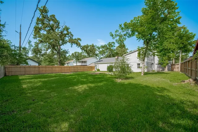 a view of yard with grass and trees