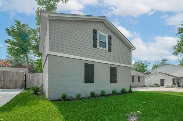 a view of backyard of house with green space