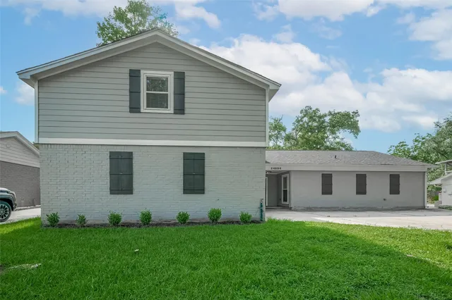 a front view of house with yard and green space