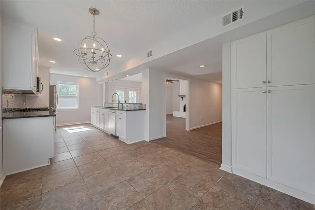 a view of a kitchen with a sink and refrigerator