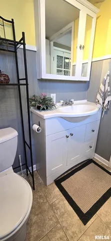 a bathroom with a sink a toilet and a mirror