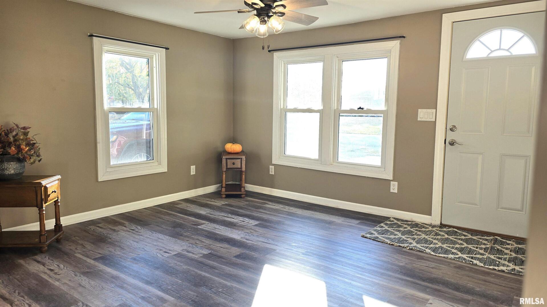 1006 8th Street Colona, IL 61241 - Photo 4 of 16 a view of an empty room with window and wooden floor