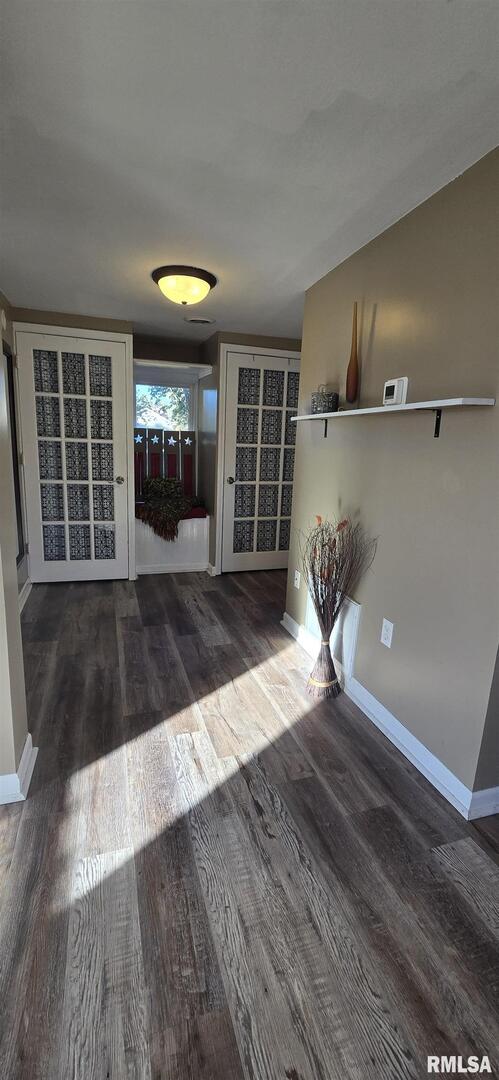 1006 8th Street Colona, IL 61241 - Photo 9 of 16 an empty room with wooden floor and windows