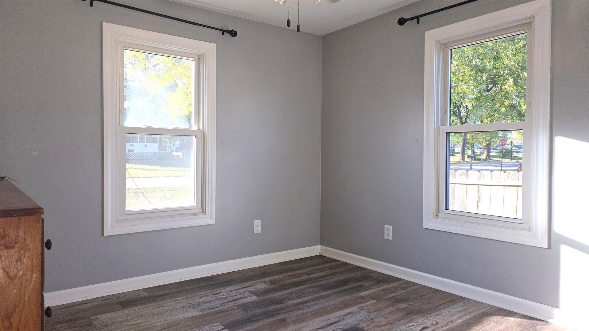 1006 8th Street Colona, IL 61241 - Photo 10 of 16 a view of an empty room with wooden floor and a window