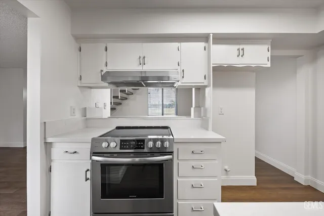 a stove top oven sitting inside of a kitchen