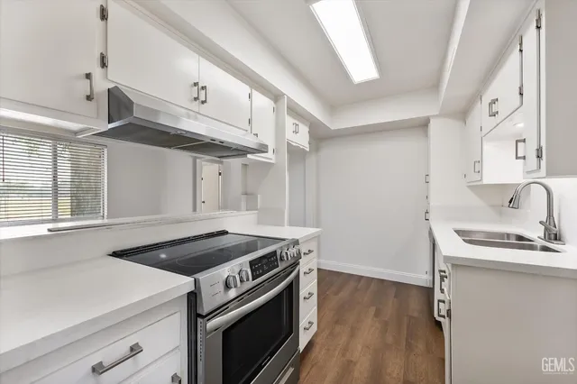 a kitchen with a stove and a sink