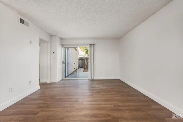 a view of an empty room and wooden floor