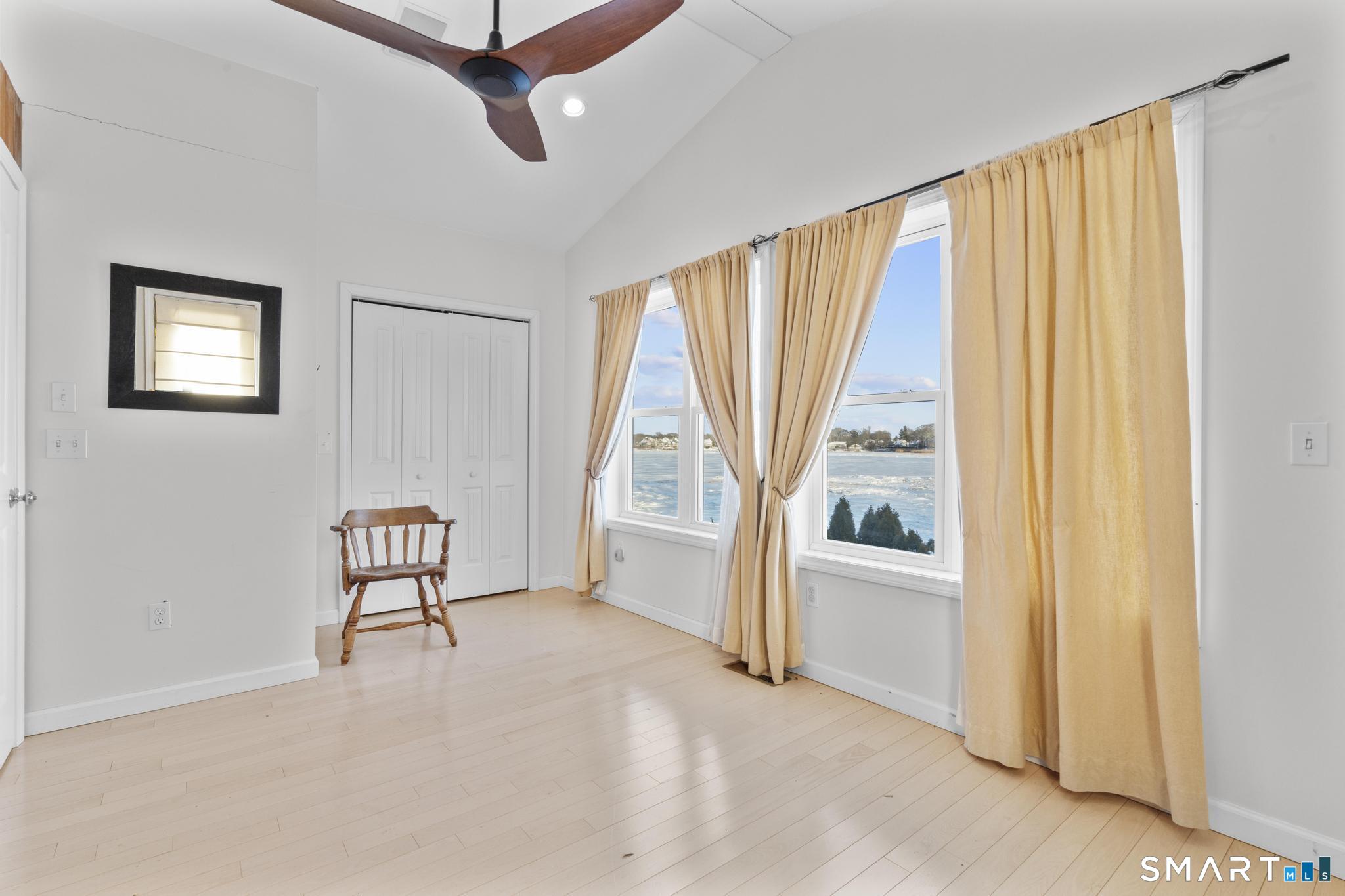 231 Pawson Road Branford, CT 06405 - Photo 15 of 17 a view of a livingroom with a ceiling fan and a window