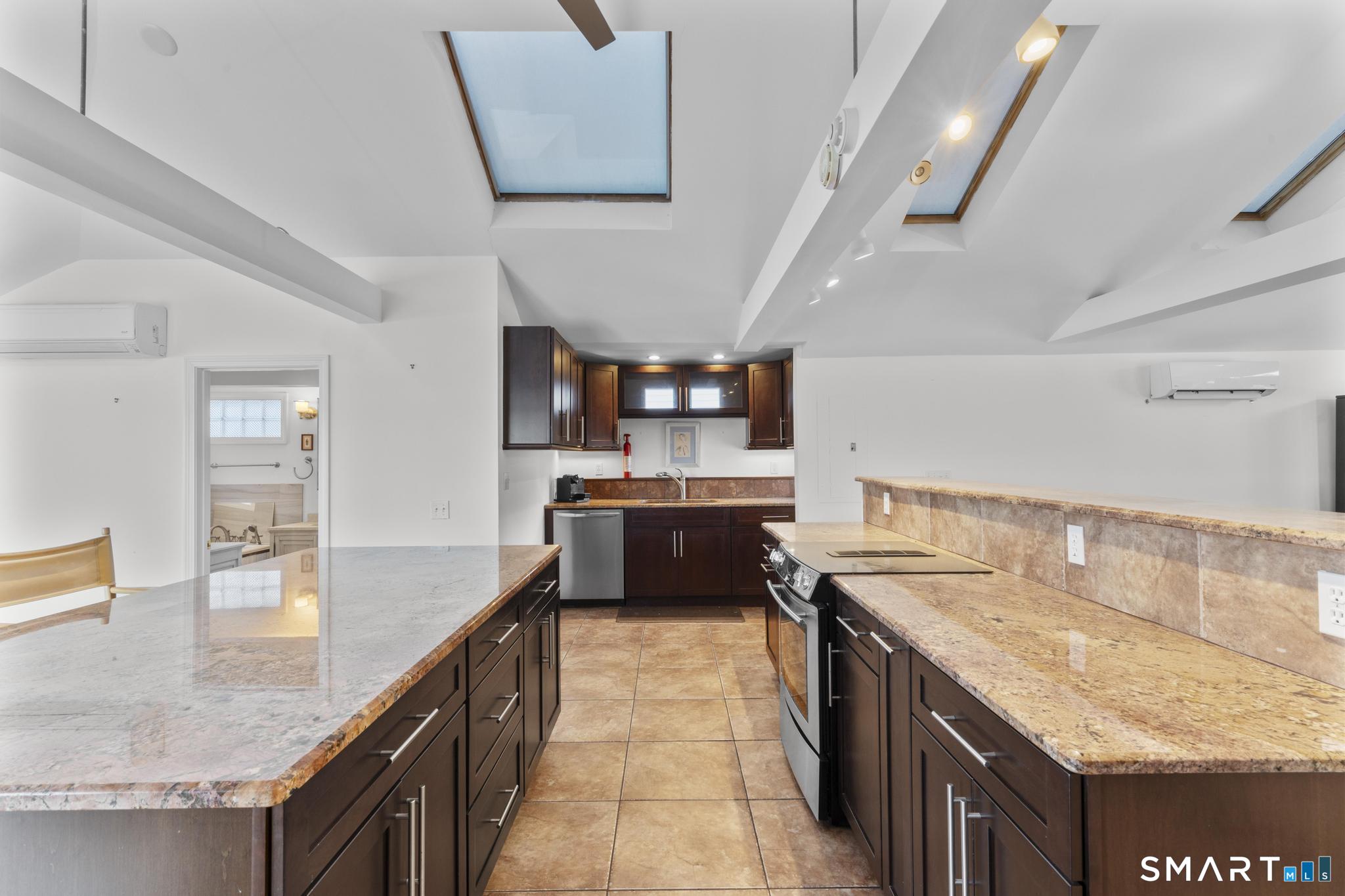 231 Pawson Road Branford, CT 06405 - Photo 10 of 17 a kitchen with stainless steel appliances granite countertop a sink counter space and cabinets