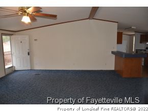 4960 Lobelia Road Vass, NC 28394 - Photo 6 of 25 a view of a livingroom with a ceiling fan and wooden floor