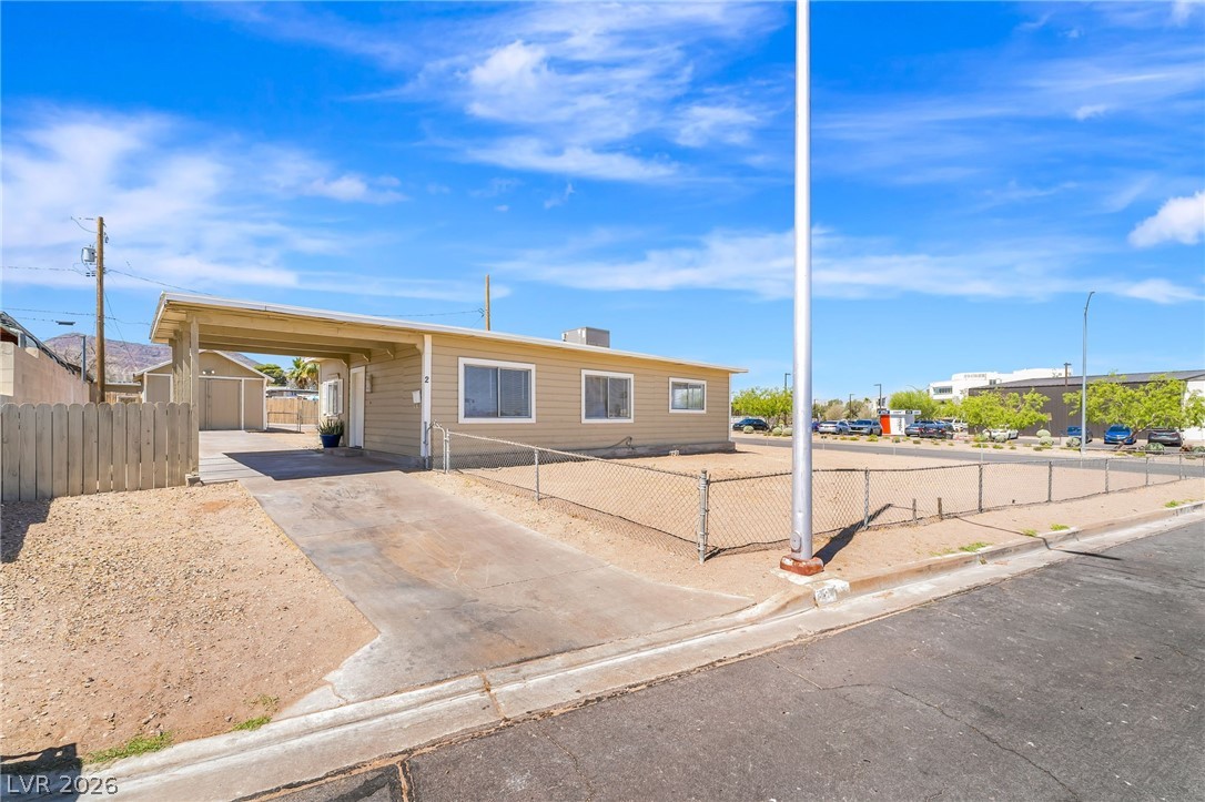 2 California Way Henderson, NV 89015 - Photo 4 of 29 A well-maintained facade with an attached carport offers convenient covered parking.