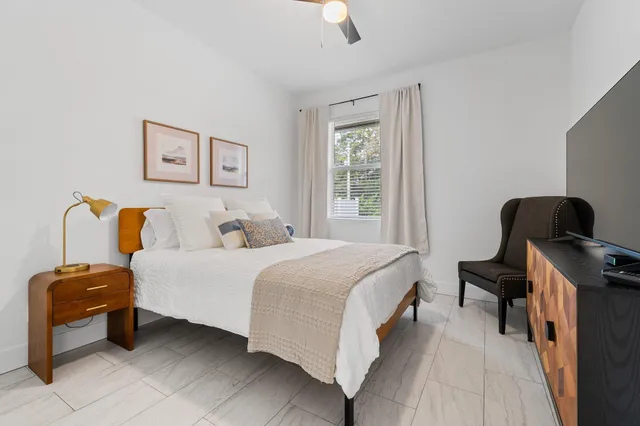 a bedroom with a bed and a chair