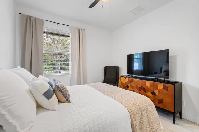 a bedroom with a bed and a television