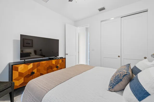 a bedroom with a bed and a flat screen tv