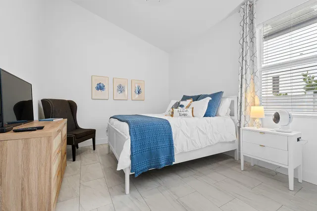 a bedroom with a bed and a desk