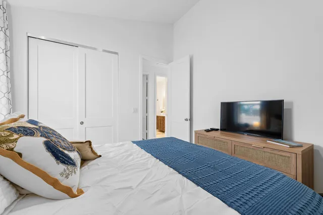 a bedroom with a bed and a flat screen tv