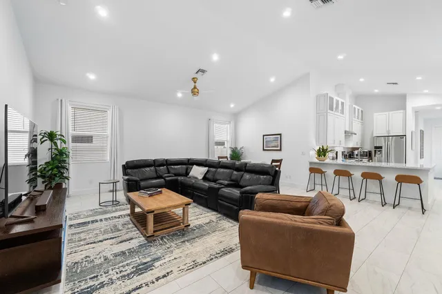 a living room with furniture kitchen and a table