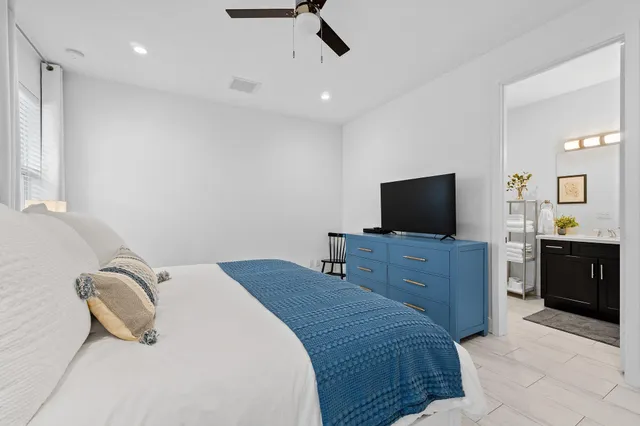 a bedroom with a bed and a television