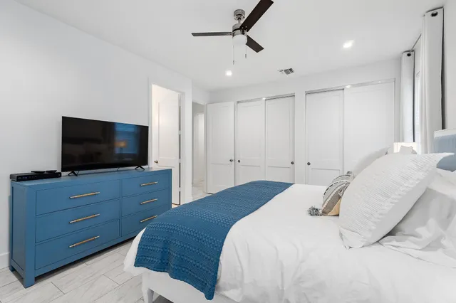 a bedroom with a bed and a flat screen tv