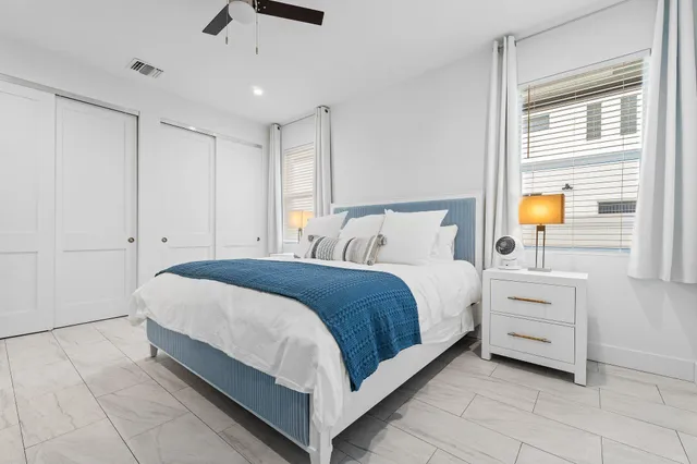 a bedroom with a bed and a window