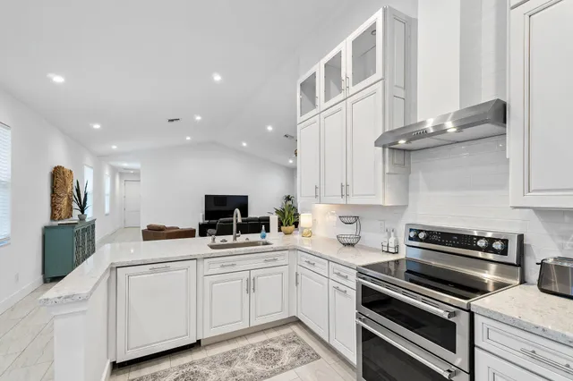 a kitchen with cabinets appliances and a counter space