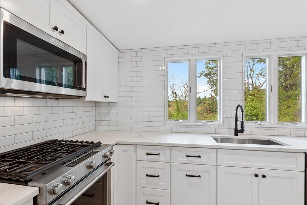 68 Still River Road Harvard, MA 01451 - Photo 23 of 40 a kitchen with stainless steel appliances a stove sink and microwave