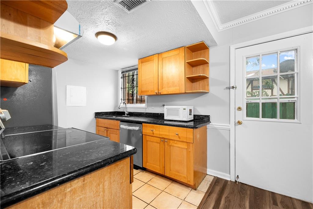 2956 North Dekalb Drive, Unit C Atlanta, GA 30340 - Photo 11 of 25 a kitchen with stainless steel appliances granite countertop a sink and a stove