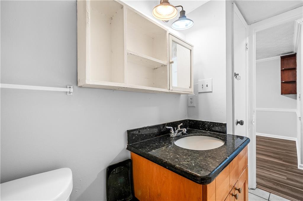 2956 North Dekalb Drive, Unit C Atlanta, GA 30340 - Photo 13 of 25 a bathroom with a granite countertop sink and a mirror