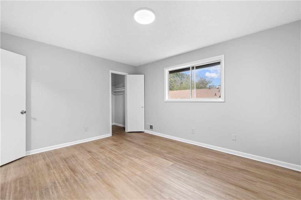 2956 North Dekalb Drive, Unit C Atlanta, GA 30340 - Photo 19 of 25 an empty room with wooden floor and windows