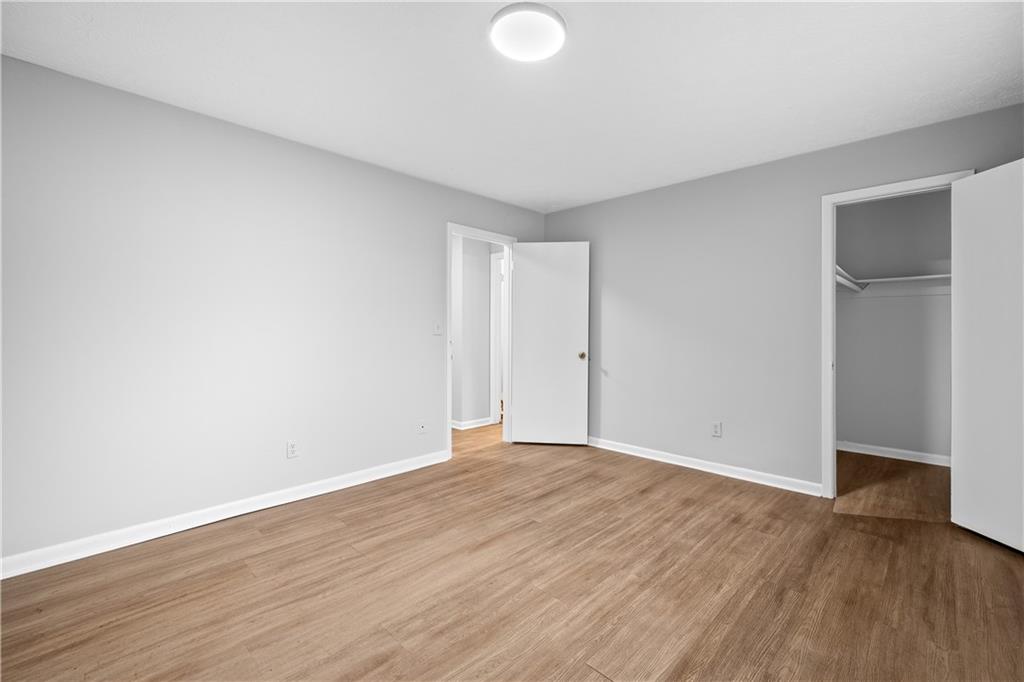 2956 North Dekalb Drive, Unit C Atlanta, GA 30340 - Photo 20 of 25 an empty room with wooden floor and windows