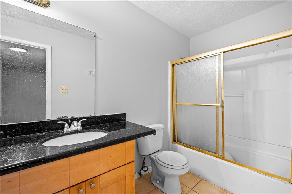 2956 North Dekalb Drive, Unit C Atlanta, GA 30340 - Photo 21 of 25 a bathroom with a granite countertop sink toilet and shower