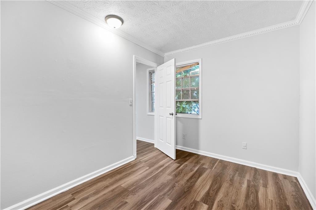 2956 North Dekalb Drive, Unit C Atlanta, GA 30340 - Photo 5 of 25 a view of an empty room with wooden floor and a window