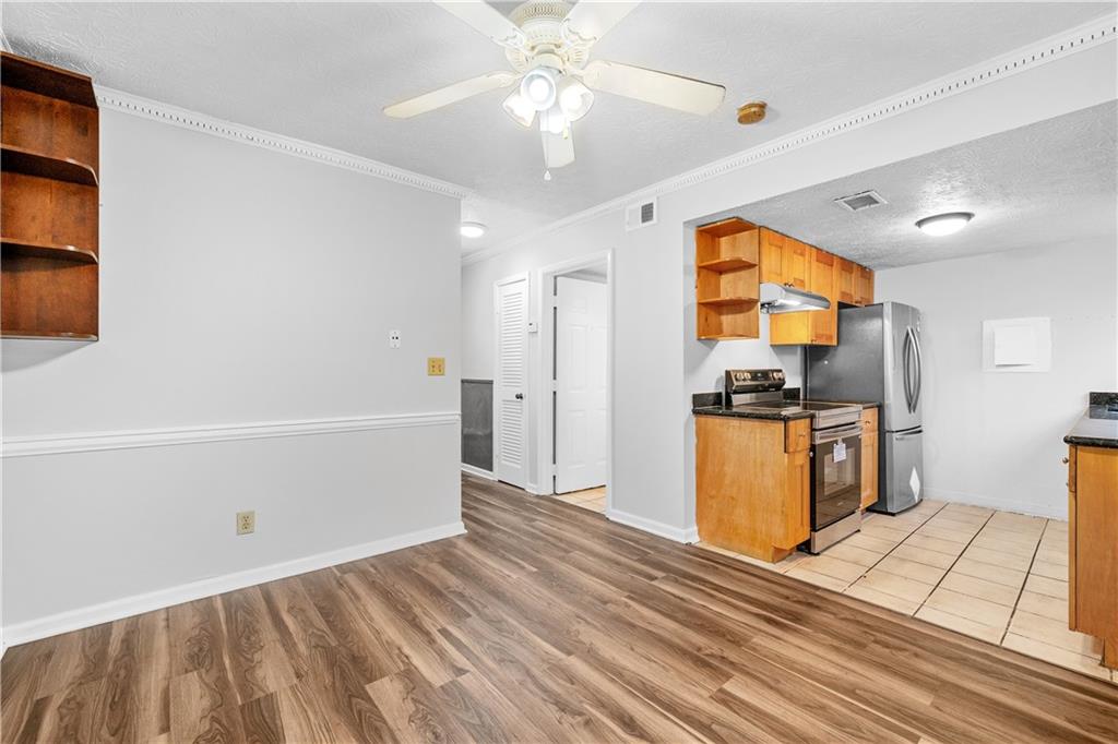 2956 North Dekalb Drive, Unit C Atlanta, GA 30340 - Photo 6 of 25 a kitchen with stainless steel appliances a refrigerator and a stove top oven