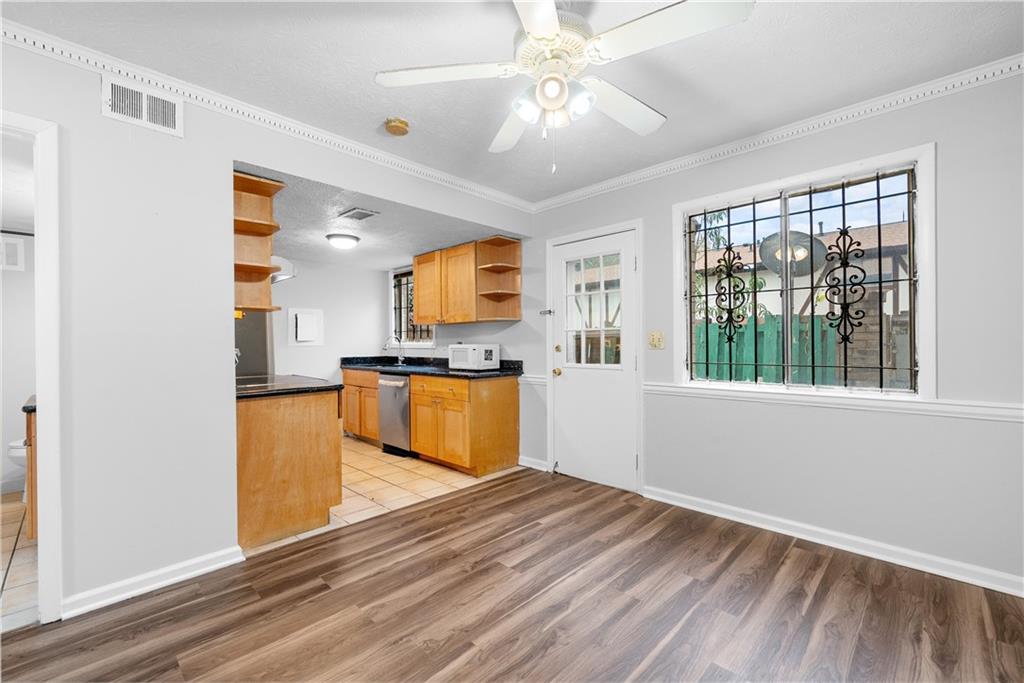 2956 North Dekalb Drive, Unit C Atlanta, GA 30340 - Photo 7 of 25 a view of a kitchen with wooden floor and a ceiling fan