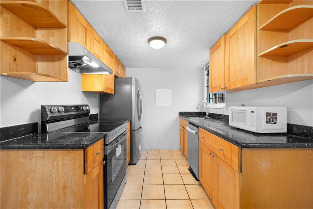 2956 North Dekalb Drive, Unit C Atlanta, GA 30340 - Photo 9 of 25 a kitchen with stainless steel appliances granite countertop a sink stove and refrigerator