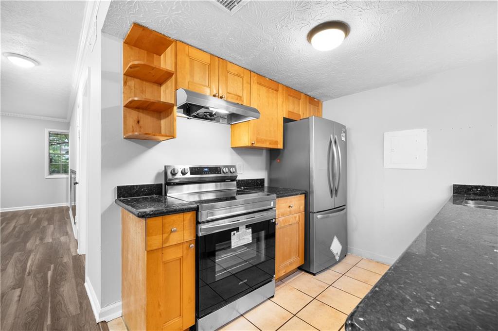 2956 North Dekalb Drive, Unit C Atlanta, GA 30340 - Photo 10 of 25 a kitchen with stainless steel appliances granite countertop a stove a refrigerator and a microwave