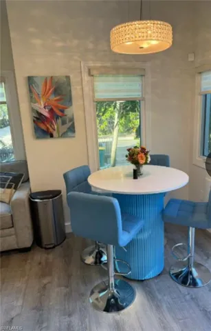 a dining room with furniture a window and a chandelier