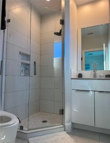 a bathroom with a shower a toilet and sink